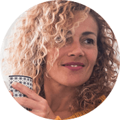 Customer Testimonial from Lisa Freeman in Owings Mills, MD Female Maryland homeowner holding a mug and smiling because she is happy with her pest control